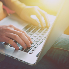 person typing on laptop