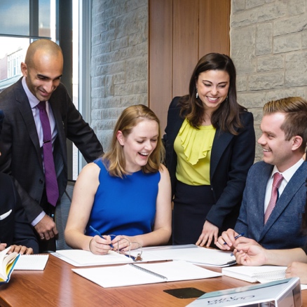 Students meet in a boardroom in Goodes Hall