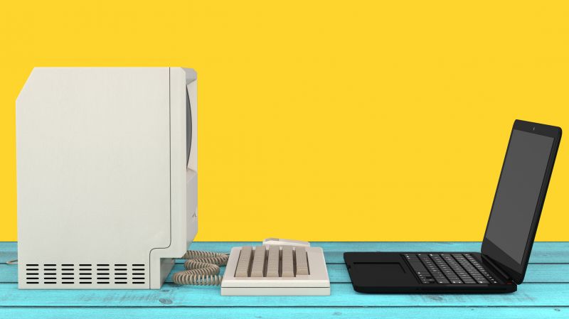 Laptop, computer and the old keybord on a yellow background