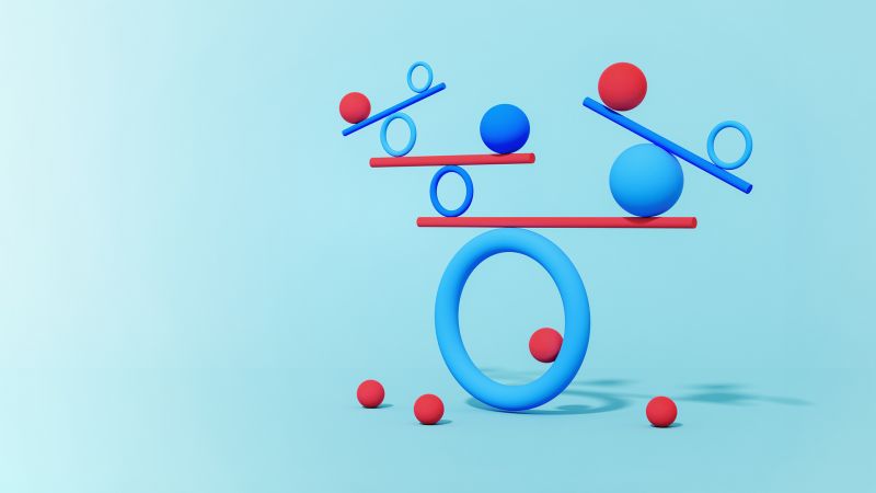 Blue balls and hoops balancing on top of red beams. Balance concept