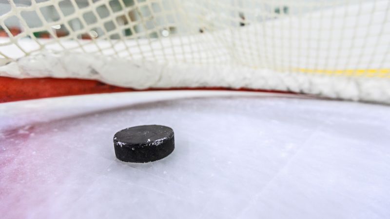 Black hockey chip on the ice field