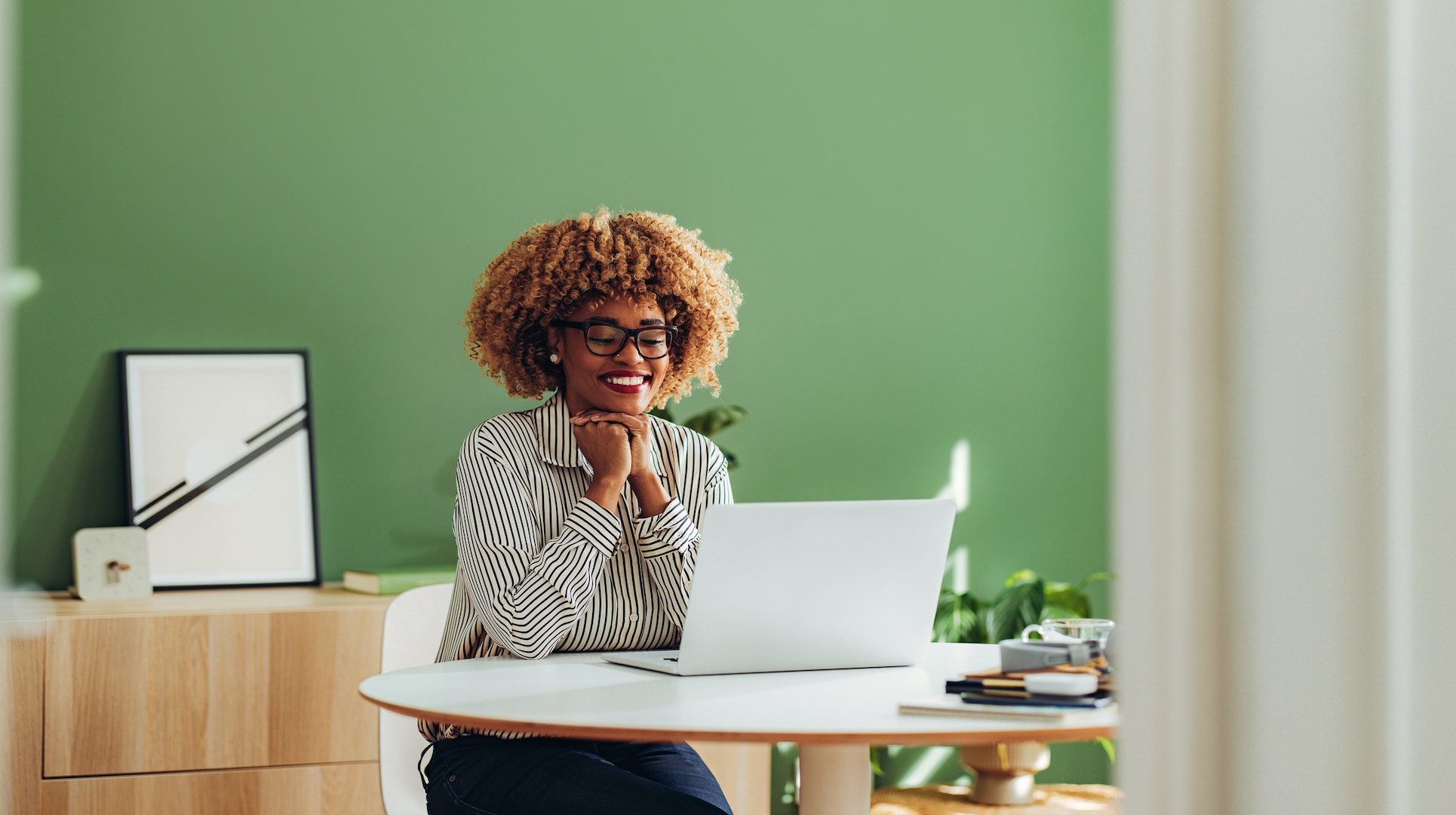 Happy businesswoman working on her laptop computer