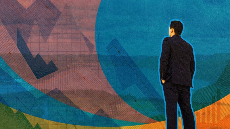 An Indigenous business man looks out only a mountain with financial graphs overalyed