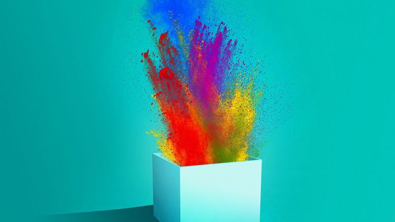 Image of a box with colorful paints on a mint background.