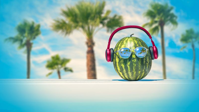 A watermelon listens to a podcast wearing headphones on a bright background.
