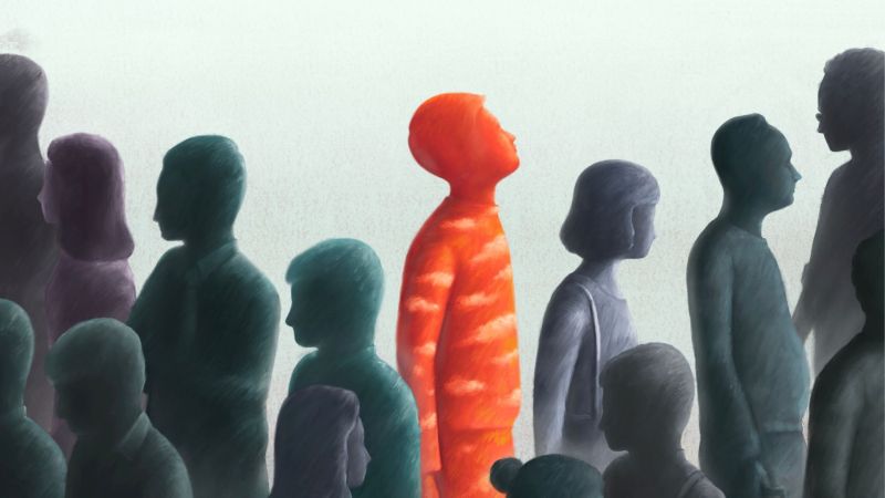 A red silhouette of a man looking at the sky amongst a crowd of people. 