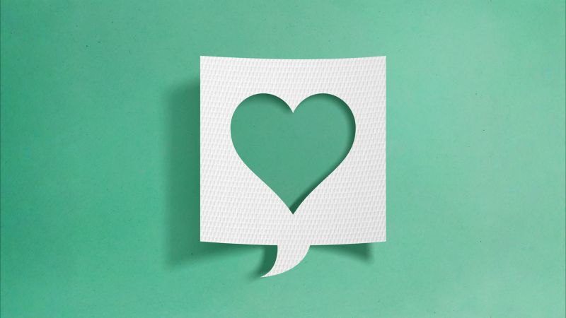 Paper speech bubble with hearth symbol cutout on green background. Gratitude concept.