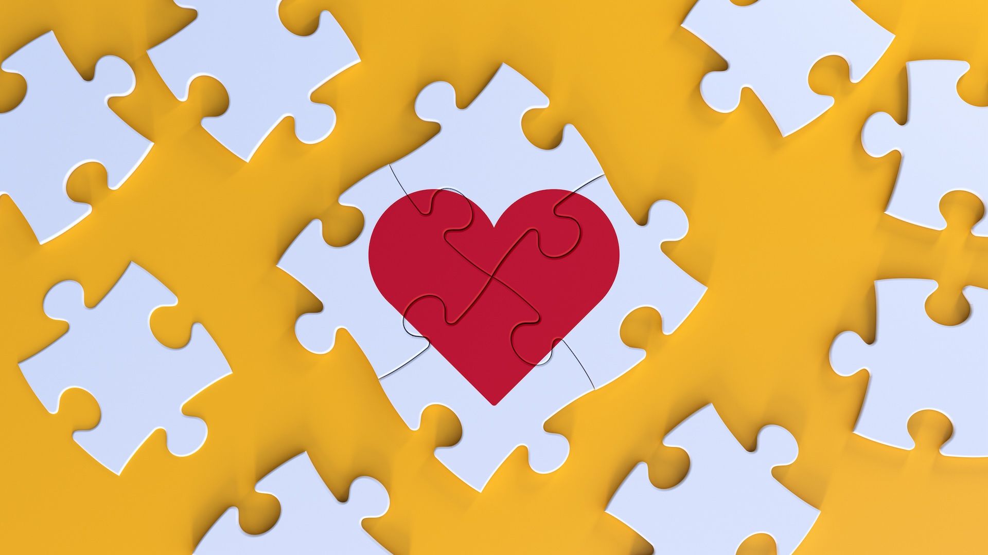 Puzzle pieces fitting together to form a heart