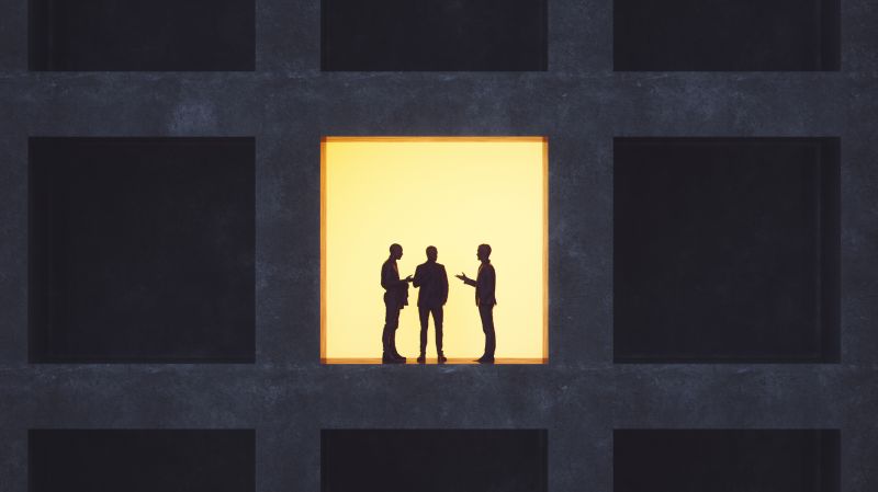 The image of three persons in the window