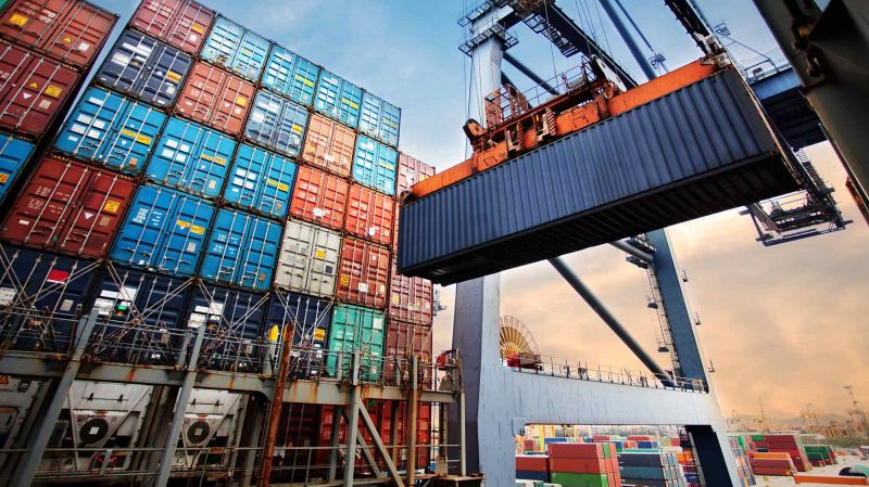 Container loading in a cargo freight ship with industrial crane.