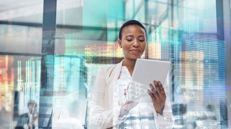 Multiple exposure shot of a mature Black businesswoman using a digital tablet in a boardroom superimposed on a cityscape.