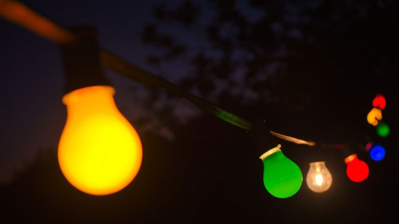 Coloured outdoor lightbulbs at night. 