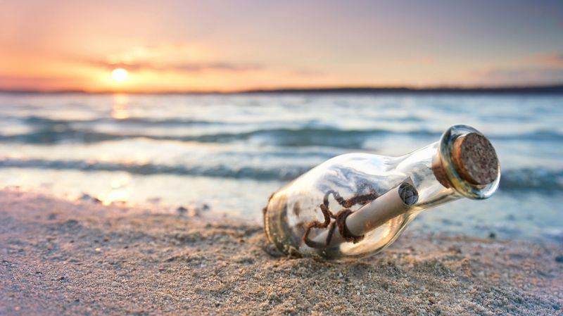 Message in a bottle at the beach.