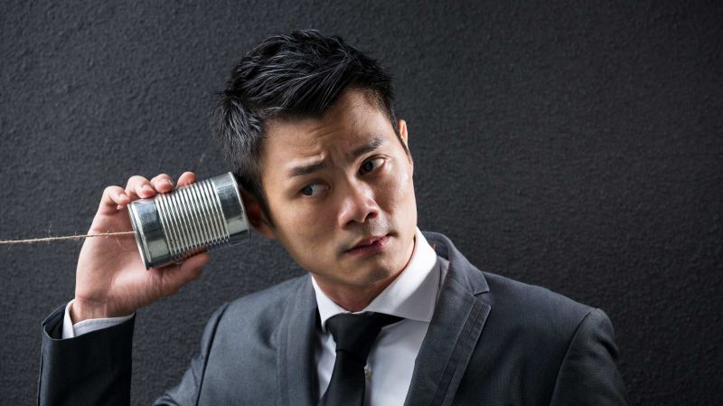 Asian Business man with tin can phone. Concept about communication.