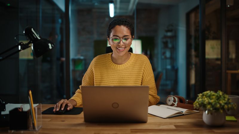 A young entrepreneur sits in front of a laptop.