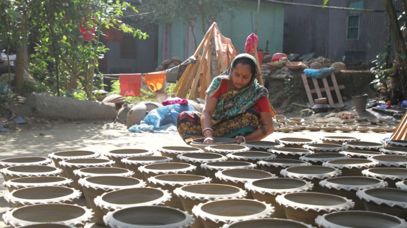 DHAKA CITY, BANGLADESH - AUGUST 22, 2021: A woman from Tangail manufacturing pottery.