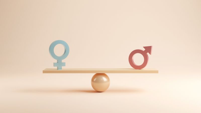 Male and female symbols balanced on a scale.