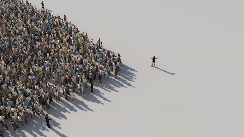 A single leader shows the direction to a large crowd.