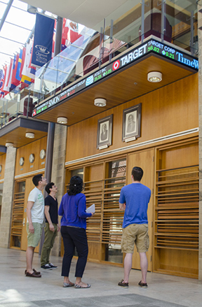 MBA students check out the new stock ticker in Goodes Hall