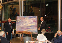 Bob Willoughby presents David Saunders with a painting by Susan G. Scott in recognition of classmate and former Dean John Gordon and a sculpture by the class’s former professor Brian Dixon.