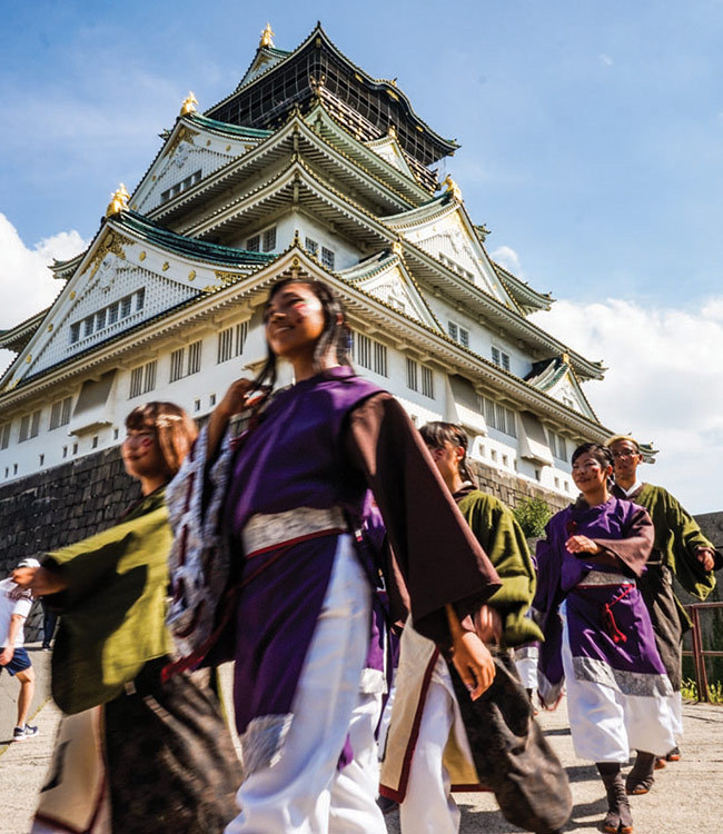 Traditional dancers in front of Osaka Castle in Japan