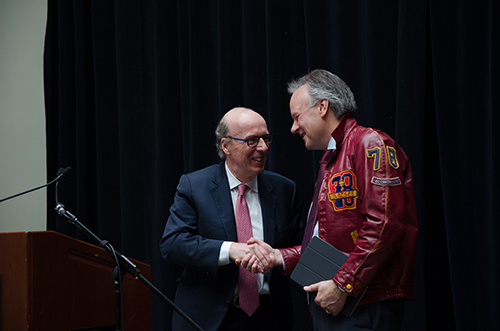 Bank of Canada Governor Stephen Poloz (right), here with Stephen Smith, wore his Queen's jacket when he spoke at Smith School of Business on Tuesday.