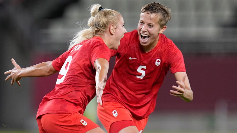 From left: Adriana Leon and Quinn celebrate at the Tokyo 2020 Olympic Games.