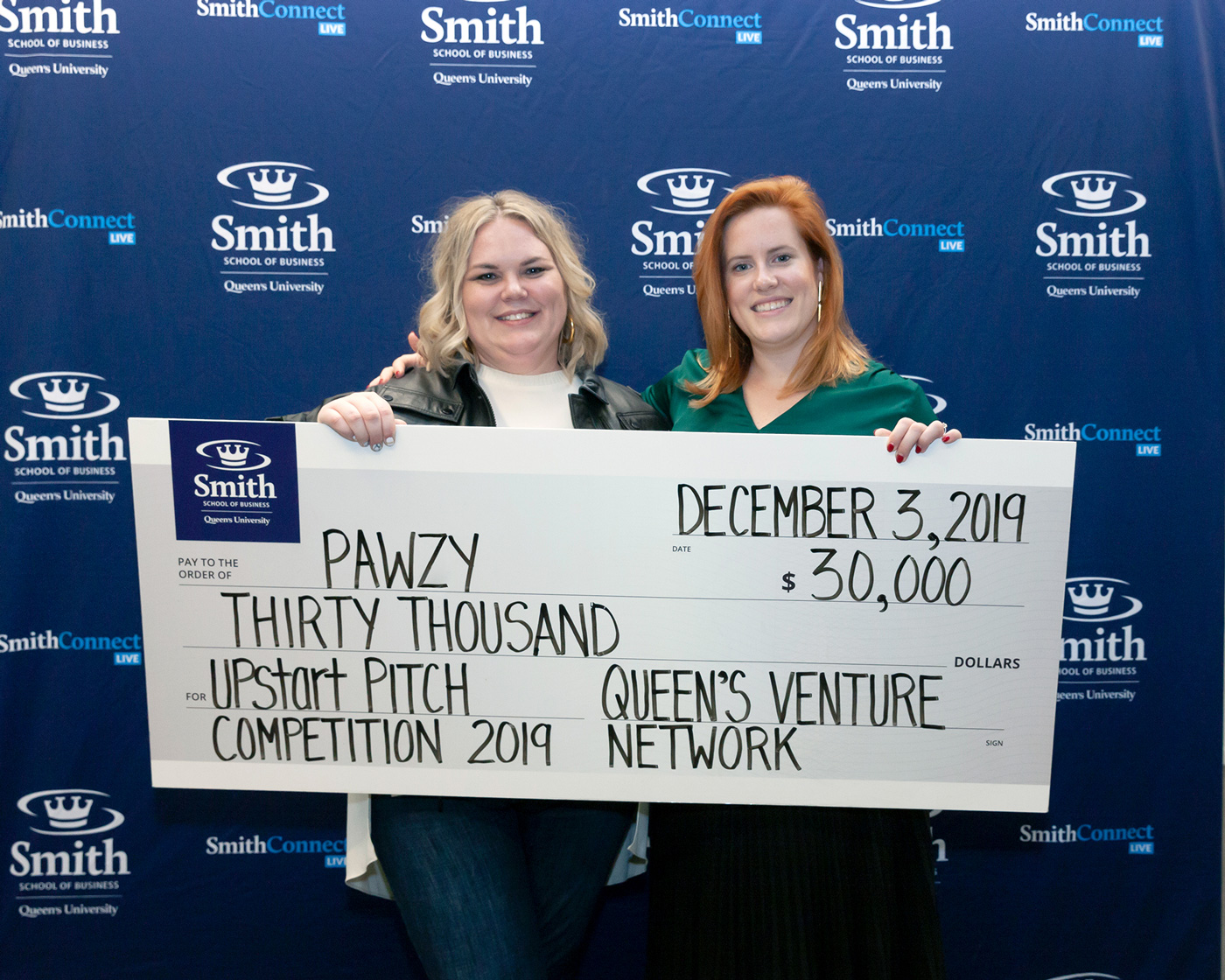 Kerri-Lynn McAllister, BCom'07, founder of Pawzy, and colleague Emma Harris, receiving the top prize at Upstart Venture Challenge.