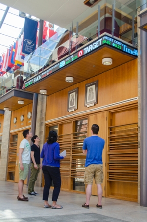MBA students check out the new stock ticker in Goodes Hall